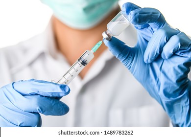Doctor, Nurse, Scientist Hand In Blue Gloves Holding Flu, Measles, Coronavirus, Covid-19 Vaccine Disease Preparing For Child, Baby, Adult, Man And Woman Vaccination Shot, Medicine And Drug Concept.