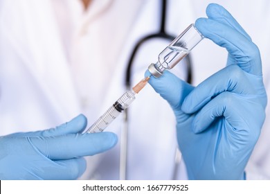 Doctor, Nurse Or Scientist Hand In Blue Nitrile Gloves Holding Flu, Measles, Coronavirus Vaccine Shot For Diseases Outbreak Vaccination, Medicine And Drug Concept