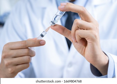 Doctor, Nurse Or Scientist Hand Holding Flu, Measles, Coronavirus Vaccine Shot For Diseases Outbreak Vaccination, Medicine And Drug Concept