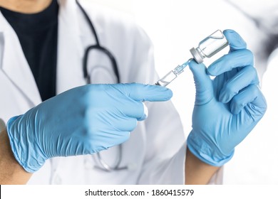 Doctor, Nurse, Scientist, Researcher Hand In Blue Gloves Holding Flu, Measles, Coronavirus, Covid-19 Vaccine Disease Preparing For Human Clinical Trials Vaccination Shot, Medicine And Drug Concept.