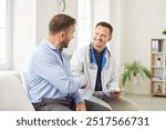 Doctor or nurse shakes hands with a male patient during visit to the hospital clinic. The handshake symbolizes professional medical care, trust, and the importance of patients healthcare.