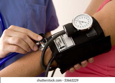 Doctor Or Nurse Taking A Patient's Blood Pressure