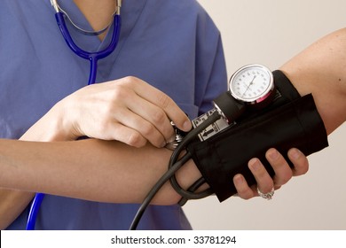 Doctor Or Nurse Taking A Patient's Blood Pressure