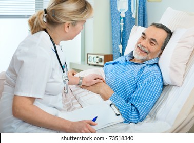 Doctor Or Nurse Talking To Patient In Hospital