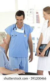 Doctor And Nurse Talking To Senior Male Patient At The Hospital