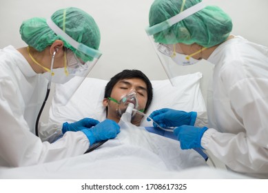 A Doctor And Nurse Treating A Patient In The Cohort Ward Of A Hospital During The Coronavirus Disease (Covid-19) Outbreak