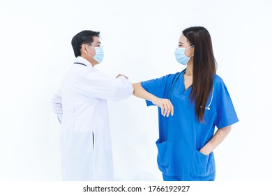 Doctor And Nurse Wear Face Mask Use Elbow Bump For Greeting With White Background. Isolated