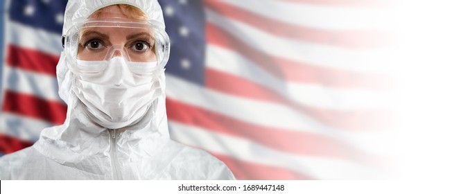 Doctor Or Nurse Wearing Medical Personal Protective Equipment (PPE) Against The American Flag Banner.