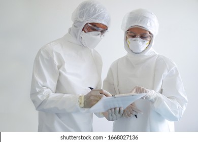 doctor and nurse are wearing PPE and looking for corona/covid-19 virus infected patient's laboratory report