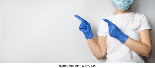 A Doctor Or Nurse Wearing Protective Blue Medical Latex Gloves And A Face Mask On A Grey Or White Background. Healthcare. Concept Of Infection Control. Copy Space.