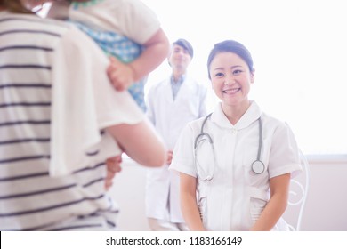 A Doctor And The Nurse Who Examine A Child