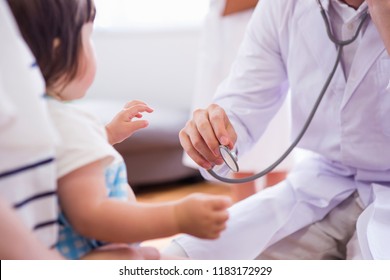 A Doctor And The Nurse Who Examine A Child