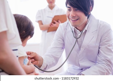 A Doctor And The Nurse Who Examine A Child