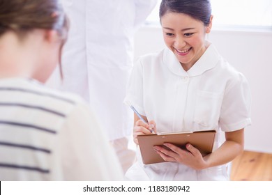 A Doctor And The Nurse Who Examine A Child