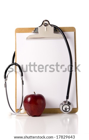 A doctor or nurses clipboard with a stethoscope and a red apple and a blank sheet of notebook paper for information or copy space.  Healthcare of health concept