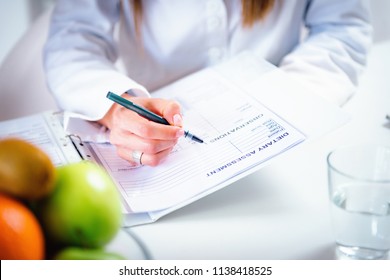 Doctor Nutritionist, Dietician And Female Patient On Consultation In The Office