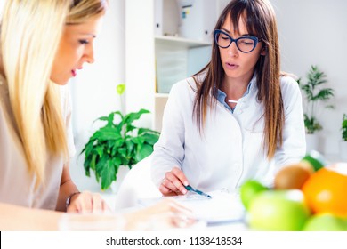 Doctor Nutritionist, Dietician And Female Patient On Consultation In The Office