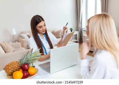 Doctor Nutritionist, Dietician And Female Patient On Consultation In The Office. Young Smiling Female Nutritionist In The Consultation Room. Nutritionist Desk With Healthy Fruit And Measuring Tape.