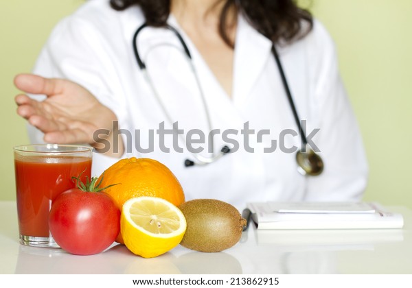 Doctor nutritionist in office with healthy fruits\
diet concept