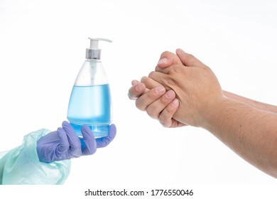 Doctor Offering Hand Sanitizer To Patient On White Background