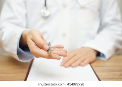 Doctor Is Offering Pen To Sign Medical Document Or Permission