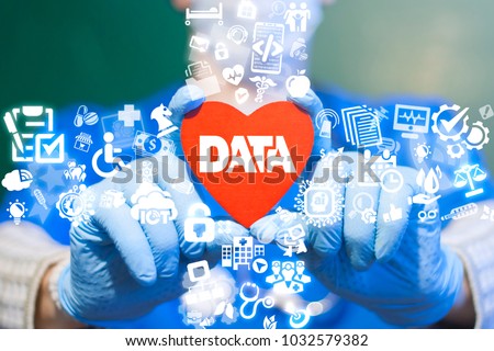 Doctor offers red heart with data text icon on a virtual interface. Big Data Medicine Modern Health Cre Information Technology concept. Smart Heart Bigdata CardiologyTech.