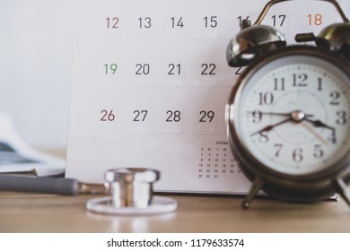 Doctor Office With Calendar , Alarm Clock And Stethoscope On Desk 