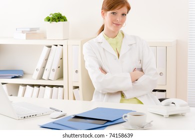 Doctor office - portrait female physician sit by desk - Powered by Shutterstock