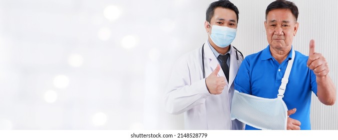 Doctor With Old Man Patient With Broken Arm On Gray Background.