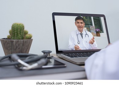 Doctor on video conference or teleconference, dicussing on case study via laptop computer in doctor room. Medical student studying with professor on internet channel. Telemedicine concept