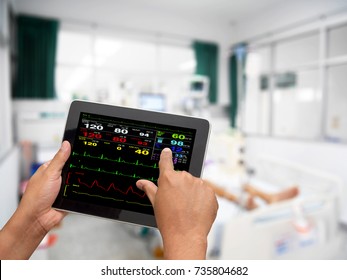 Doctor Online Checking Patient Monitor By Use Tablet And Wifi Technology In Intensive Care Unit (ICU), Tablet Telehealth Concept, Remote Medical Doctor Monitoring