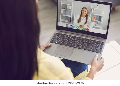 Doctor Online. A Woman In Casual Clothes Is Listening To A Video Call Consulting A Doctor From Skype Laptop At Home.