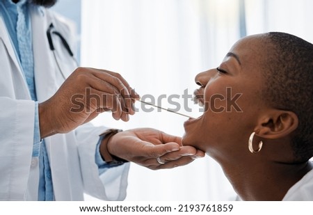 Doctor, otolaryngologist or dentist with a medical instrument checking the throat for tonsils or oral cancer. Health, healthcare worker and wellness with an ent specialist examining a black woman