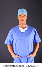 Doctor Over Dark Background In Blue Shirt