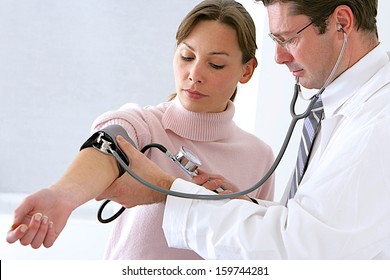 Doctor And Patient Blood Pressure Check Up - Female Patient's Arm Extended