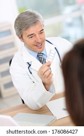 Doctor With Patient In Consultation Room