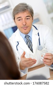 Doctor With Patient In Consultation Room