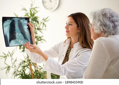 Doctor and patient discussing scan results in hospital - Powered by Shutterstock