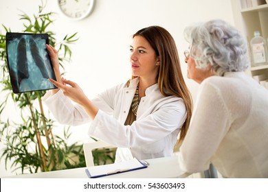 Doctor And Patient Discussing Scan Results In Hospital