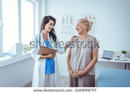 Doctor and patient discussing something at hospital . Medicine and health care concept. Doctor and patient. Patient Having Consultation With Doctor In Office. 