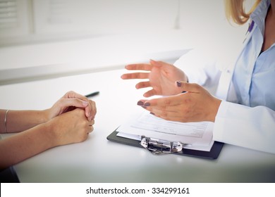 Doctor and patient are discussing something, just hands at the table