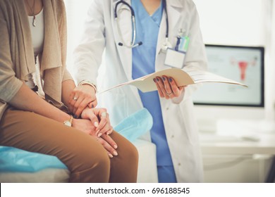 Doctor and patient discussing something while sitting at the table . Medicine and health care concept. Doctor and patient - Powered by Shutterstock