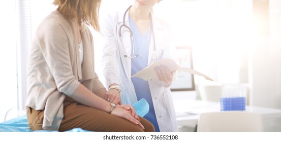 Doctor and patient discussing something while sitting at the table . Medicine and health care concept. Doctor and patient - Shutterstock ID 736552108
