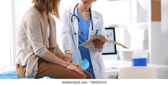 Doctor and patient discussing something while sitting at the table . Medicine and health care concept. Doctor and patient - Shutterstock ID 736555114