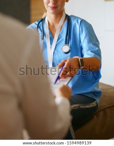 Similar – Doctor giving a prescription to senior patient