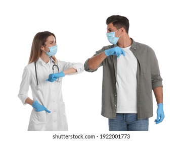 Doctor And Patient Doing Elbow Bump Instead Of Handshake On White Background. New Greeting During COVID-19 Pandemic