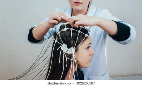 Doctor And Patient With Encephalography Electrode. Electroencephalogram (EEG)