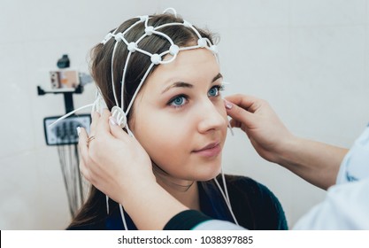 Doctor And Patient With Encephalography Electrode. Electroencephalogram (EEG)