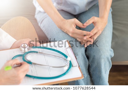 Doctor and patient healthcare concept. Gynecologist physician consulting and examining woman patient health in Obstetrics and Gynecology department in medical hospital health service center.