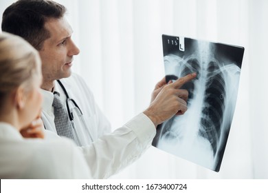 Doctor and patient looking at x-ray - Powered by Shutterstock